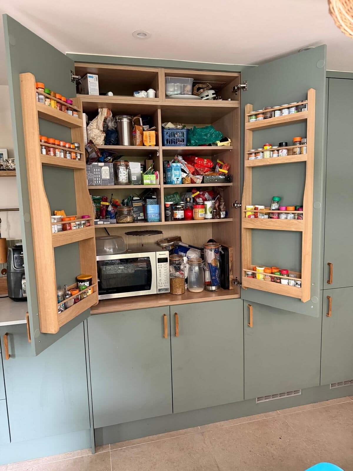 Sage larder with shelves on the doors