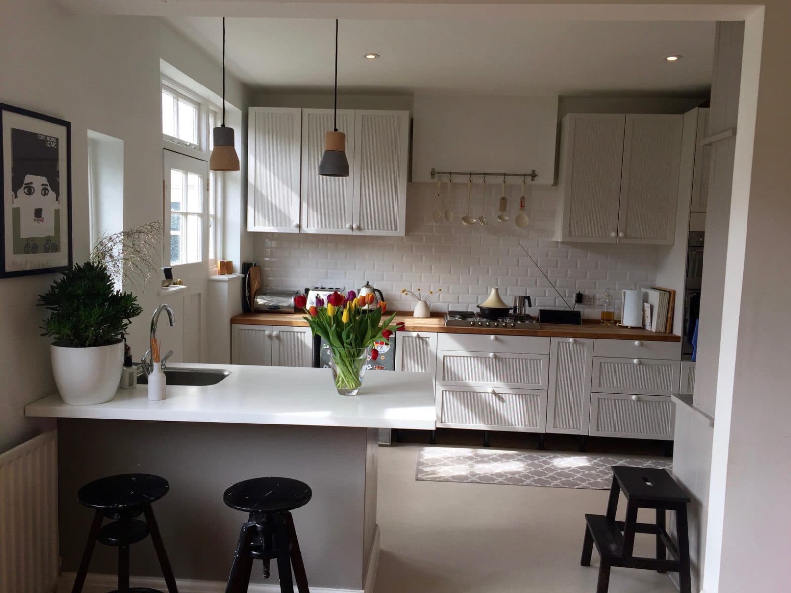 Breakfast bar detail: quartz top, painted in-frame doors from our workshop.